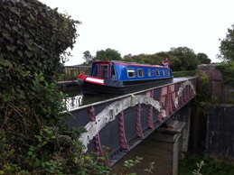 A boat crosses a bridge